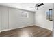 Bedroom featuring hardwood floors, fresh paint, ceiling fan, and two windows at 60 Highland Dr, Stockbridge, GA 30281