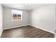 Bright bedroom features hardwood floors, fresh paint, and a window with exterior view at 60 Highland Dr, Stockbridge, GA 30281