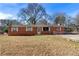 Charming brick ranch-style home with a well-maintained front yard and a covered carport at 60 Highland Dr, Stockbridge, GA 30281