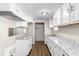 Bright kitchen featuring new white cabinets, granite countertops, and updated appliances at 60 Highland Dr, Stockbridge, GA 30281