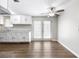 Open kitchen and dining area with stylish cabinets, countertops, ceiling fan, and a backyard view at 60 Highland Dr, Stockbridge, GA 30281