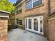Private brick back patio with double french doors and ample sunlight, surrounded by a lovely garden and greenery at 6980 Roswell Rd # J6, Atlanta, GA 30328