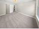 Large carpeted bedroom with neutral walls, natural light, and entryways to other rooms at 6980 Roswell Rd # J6, Atlanta, GA 30328