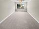 Bright bedroom with a large window and neutral carpeting, ready for personalization at 6980 Roswell Rd # J6, Atlanta, GA 30328