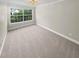 Bright bedroom featuring a large window, carpet, and natural light at 6980 Roswell Rd # J6, Atlanta, GA 30328