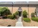 Charming brick townhome featuring a welcoming entryway and well-maintained landscaping at 6980 Roswell Rd # J6, Atlanta, GA 30328
