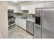 Updated kitchen with stainless steel appliances, granite countertops, and white cabinetry at 6980 Roswell Rd # J6, Atlanta, GA 30328