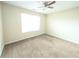 Neutral bedroom featuring a ceiling fan, carpet, and a window offering natural light at 3413 Creekview Dr, Rex, GA 30273