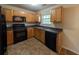 Efficient kitchen featuring wood cabinets, black appliances, and tile flooring at 3413 Creekview Dr, Rex, GA 30273