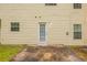 Back of house showing a small back patio with a door and windows at 4205 Post Oak Grv, Atlanta, GA 30349