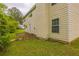 Exterior view of the back of the house and side yard with a patio and greenery at 4205 Post Oak Grv, Atlanta, GA 30349