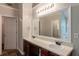 Bathroom featuring dual sinks, framed vanity mirrors, and an entrance to a walk-in closet at 4205 Post Oak Grv, Atlanta, GA 30349