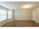 Empty carpeted bedroom featuring two windows for ample natural light and a neutral paint at 4205 Post Oak Grv, Atlanta, GA 30349