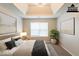 Virtually staged bedroom featuring tray ceiling, large windows, and artwork at 4205 Post Oak Grv, Atlanta, GA 30349