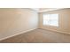 A minimalist bedroom featuring neutral walls, carpet flooring, and a window with natural light at 4205 Post Oak Grv, Atlanta, GA 30349