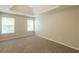 Bright empty bedroom featuring a tray ceiling and two large windows with natural light at 4205 Post Oak Grv, Atlanta, GA 30349