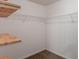 Walk-in closet with carpeted floor and wooden shelving at 4205 Post Oak Grv, Atlanta, GA 30349