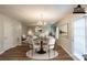 Inviting dining area featuring wood floors, a modern chandelier, and seamlessly connected living space at 4205 Post Oak Grv, Atlanta, GA 30349