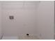 Small, empty room with a wire rack on the ceiling, utility connections and light colored flooring at 4205 Post Oak Grv, Atlanta, GA 30349