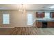 Bright dining area adjacent to the kitchen featuring dark cabinets, modern appliances, and an exterior door at 4205 Post Oak Grv, Atlanta, GA 30349
