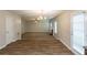 Open-concept living area showcasing wood floors and neutral paint, leading to a carpeted living room at 4205 Post Oak Grv, Atlanta, GA 30349