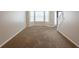 Spacious living room with a large bay window and neutral carpet, perfect for relaxation at 4205 Post Oak Grv, Atlanta, GA 30349