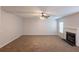 Spacious living room with plush carpeting, a cozy fireplace, and natural light from a window at 4205 Post Oak Grv, Atlanta, GA 30349