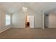 Vaulted main bedroom featuring neutral carpeting and an ensuite bathroom at 4205 Post Oak Grv, Atlanta, GA 30349