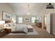 Virtually staged vaulted main bedroom with decor and furniture at 4205 Post Oak Grv, Atlanta, GA 30349