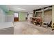 Unfinished basement with concrete floors, exposed ductwork, and a door to the backyard at 546 Wagon Wheel Climb, Lawrenceville, GA 30044