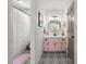 Charming bathroom featuring a pink vanity, patterned tile floor, and a separate shower, creating a stylish retreat at 546 Wagon Wheel Climb, Lawrenceville, GA 30044