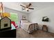 Comfortable bedroom with a twin bed, wood floors, and a bright window creating a warm and inviting space at 546 Wagon Wheel Climb, Lawrenceville, GA 30044
