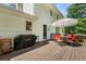 Wooden deck with outdoor seating, umbrella, and a grill at 546 Wagon Wheel Climb, Lawrenceville, GA 30044
