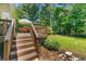 Wooden deck with steps leading to the landscaped backyard and garden area at 546 Wagon Wheel Climb, Lawrenceville, GA 30044