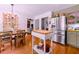 Stylish eat-in kitchen with stainless steel refrigerator and adjacent dining area at 546 Wagon Wheel Climb, Lawrenceville, GA 30044