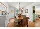 Elegant dining room with wood table, wicker chairs, decorative lighting and access to other living spaces at 546 Wagon Wheel Climb, Lawrenceville, GA 30044