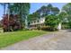 Two-story home with a well-manicured lawn and mature trees at 546 Wagon Wheel Climb, Lawrenceville, GA 30044