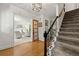 Inviting foyer with hardwood floors, staircase with decorative iron railing, and views into the living area at 546 Wagon Wheel Climb, Lawrenceville, GA 30044