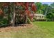 Beautifully landscaped front yard with mature trees and shrubs at 546 Wagon Wheel Climb, Lawrenceville, GA 30044