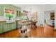 Bright kitchen features a farmhouse sink, green cabinetry, and an adjacent breakfast area at 546 Wagon Wheel Climb, Lawrenceville, GA 30044