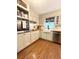 Well-lit kitchen boasts hardwood floors, white cabinets, and built-in oven at 546 Wagon Wheel Climb, Lawrenceville, GA 30044