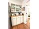 Butler's pantry features white cabinets, butcher block countertop, and lots of storage at 546 Wagon Wheel Climb, Lawrenceville, GA 30044