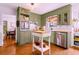 Charming kitchen features custom cabinetry, stainless steel appliances, and hardwood floors at 546 Wagon Wheel Climb, Lawrenceville, GA 30044
