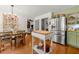 Open kitchen with stainless steel refrigerator, hardwood floors, and cozy breakfast nook at 546 Wagon Wheel Climb, Lawrenceville, GA 30044