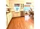Bright kitchen boasts stainless steel appliances, white cabinetry, and hardwood floors at 546 Wagon Wheel Climb, Lawrenceville, GA 30044