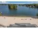 Stunning aerial view of a sandy beach along the water with picnic tables and benches at 6095 Wayfarer Dr, Villa Rica, GA 30180