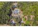 Overhead view of a community clubhouse, pool, parking lot, and playground amidst lush trees at 6095 Wayfarer Dr, Villa Rica, GA 30180