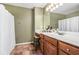 Neutral bathroom features a large mirror, tiled floors, and a wooden vanity at 6095 Wayfarer Dr, Villa Rica, GA 30180