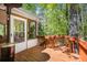 Wooden deck with railing leads to a screened porch overlooking a lush, green yard at 6095 Wayfarer Dr, Villa Rica, GA 30180