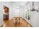 Bright dining area with wood floors, pendant lighting, and access to an enclosed outdoor space at 6095 Wayfarer Dr, Villa Rica, GA 30180
